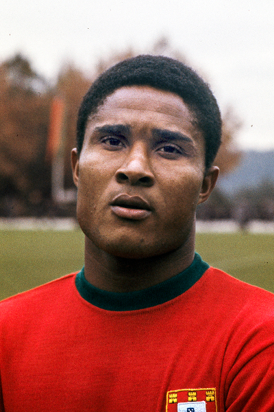 Iconic action portrait of Portuguese football legend Eusébio competing in the men's World Cup during his celebrated 1957–1979 career.