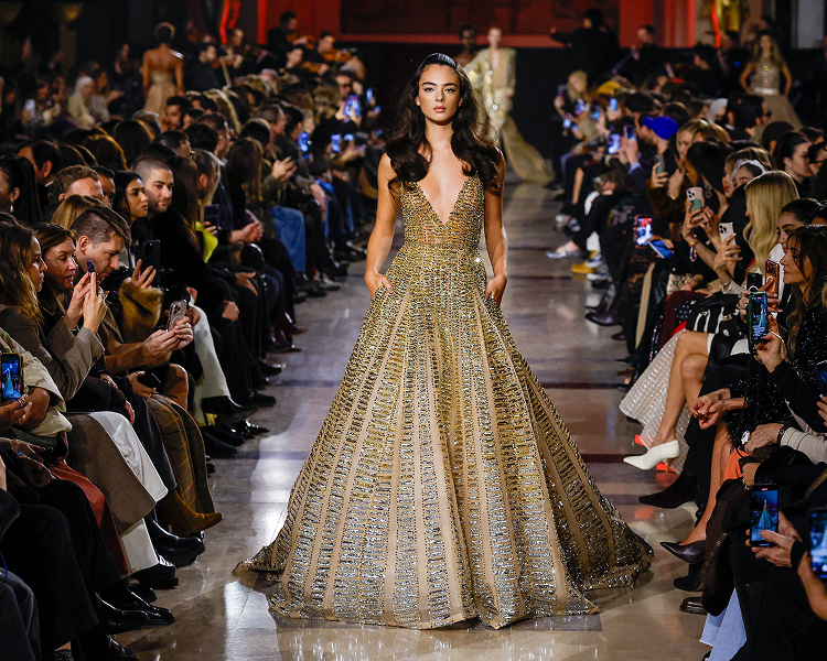 A runway model presents avant-garde designs during Haute Couture Week.