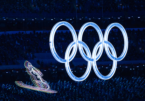 The Olympic rings displayed at an opening ceremony, an example of powerful Winter Olympics imagery for effective digital media storytelling.